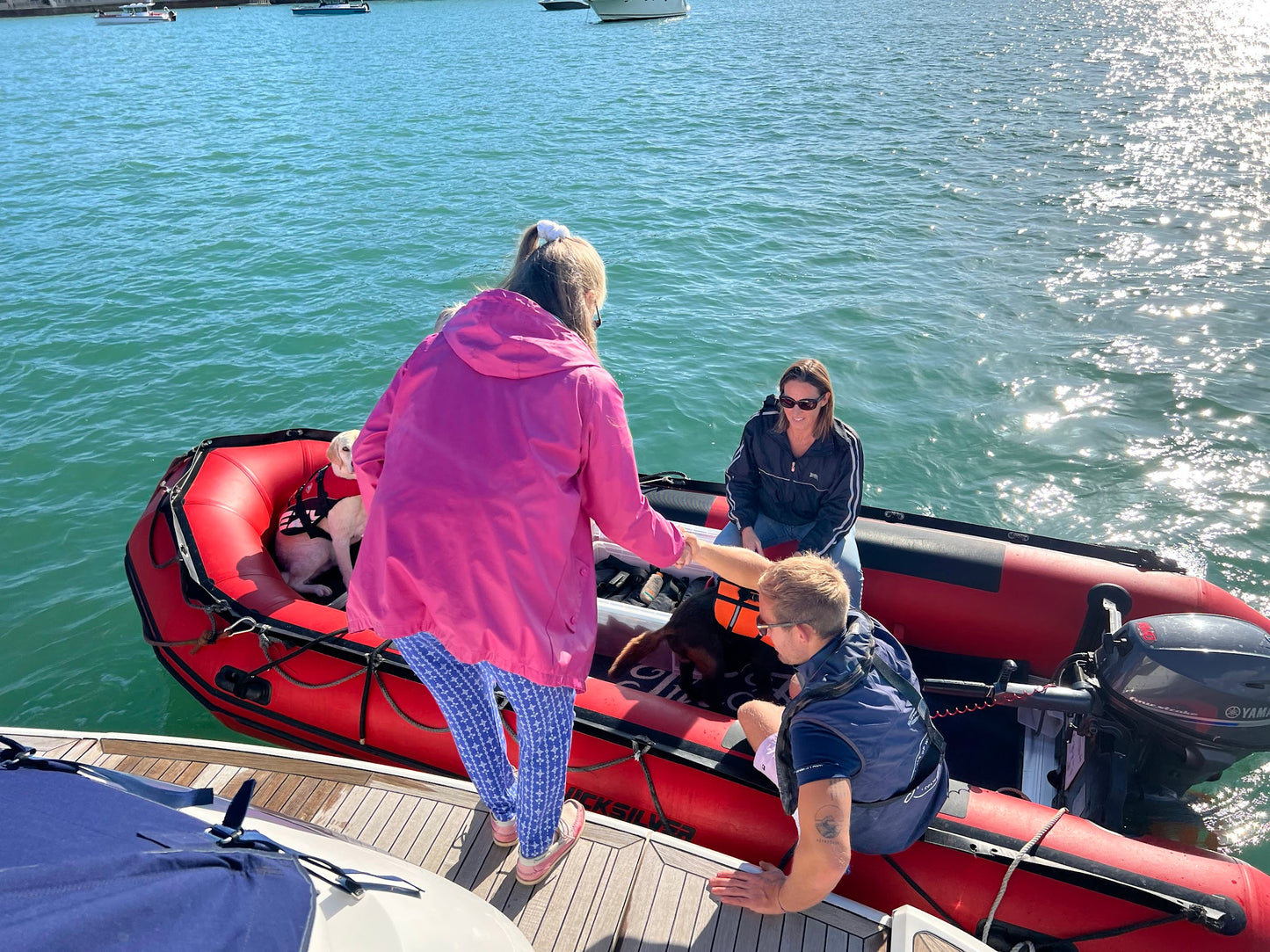 charter guests boarding a tender boat to the hut colwell bay isle of wight from the yacht